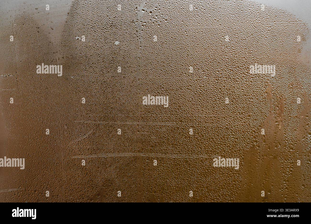 Moist glass surface covered with condensation droplets, abstract pattern of water forming texture, blurred natural light creating modern and soft back Stock Photo