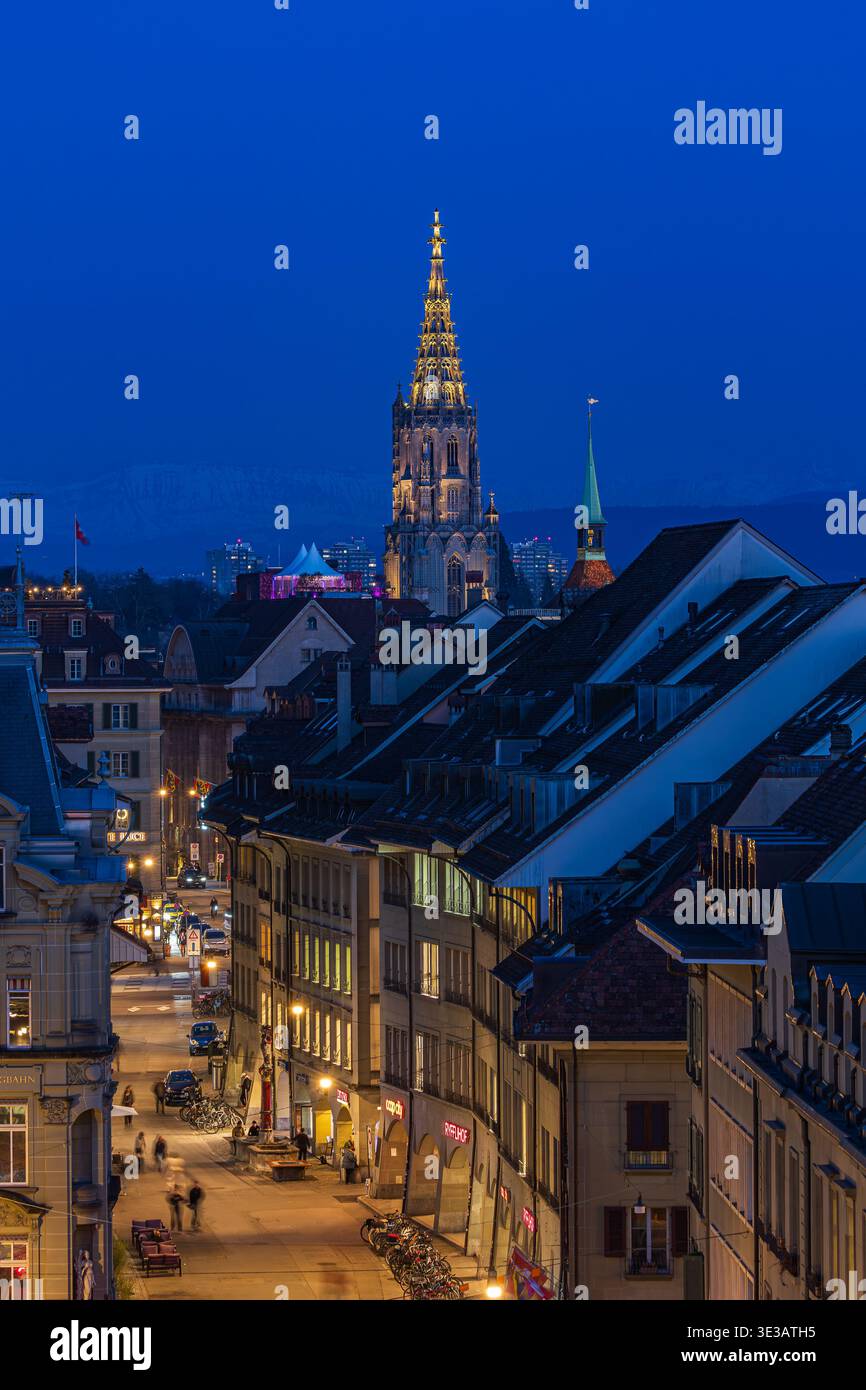 Bern, Switzerland - March 04.2026: The Munster church tower over the old town district at twilight, Bern, Switzerland Stock Photo