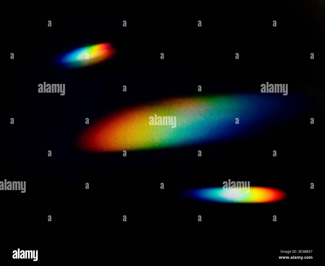Vibrant spectrum of rainbow light beams on a black background, creating ...