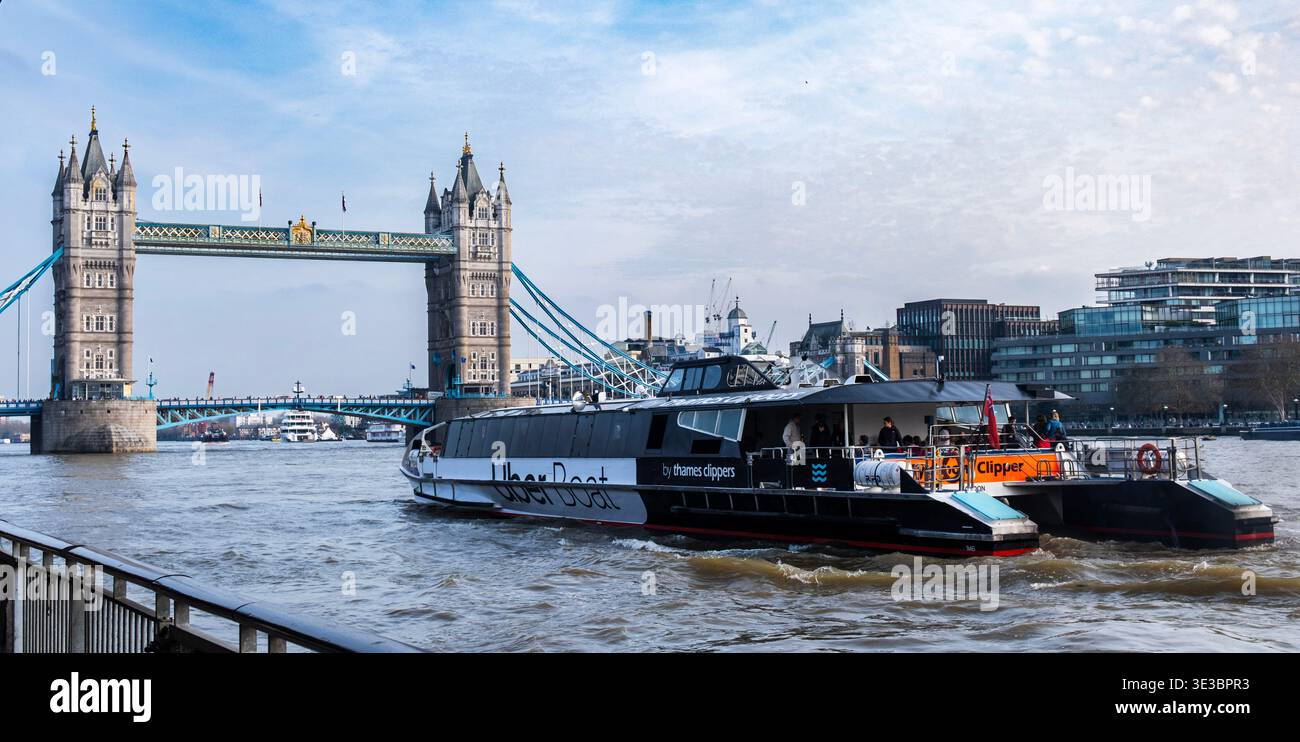 Uber Boat on the Thames heading towards Tower Bridge Stock Photo