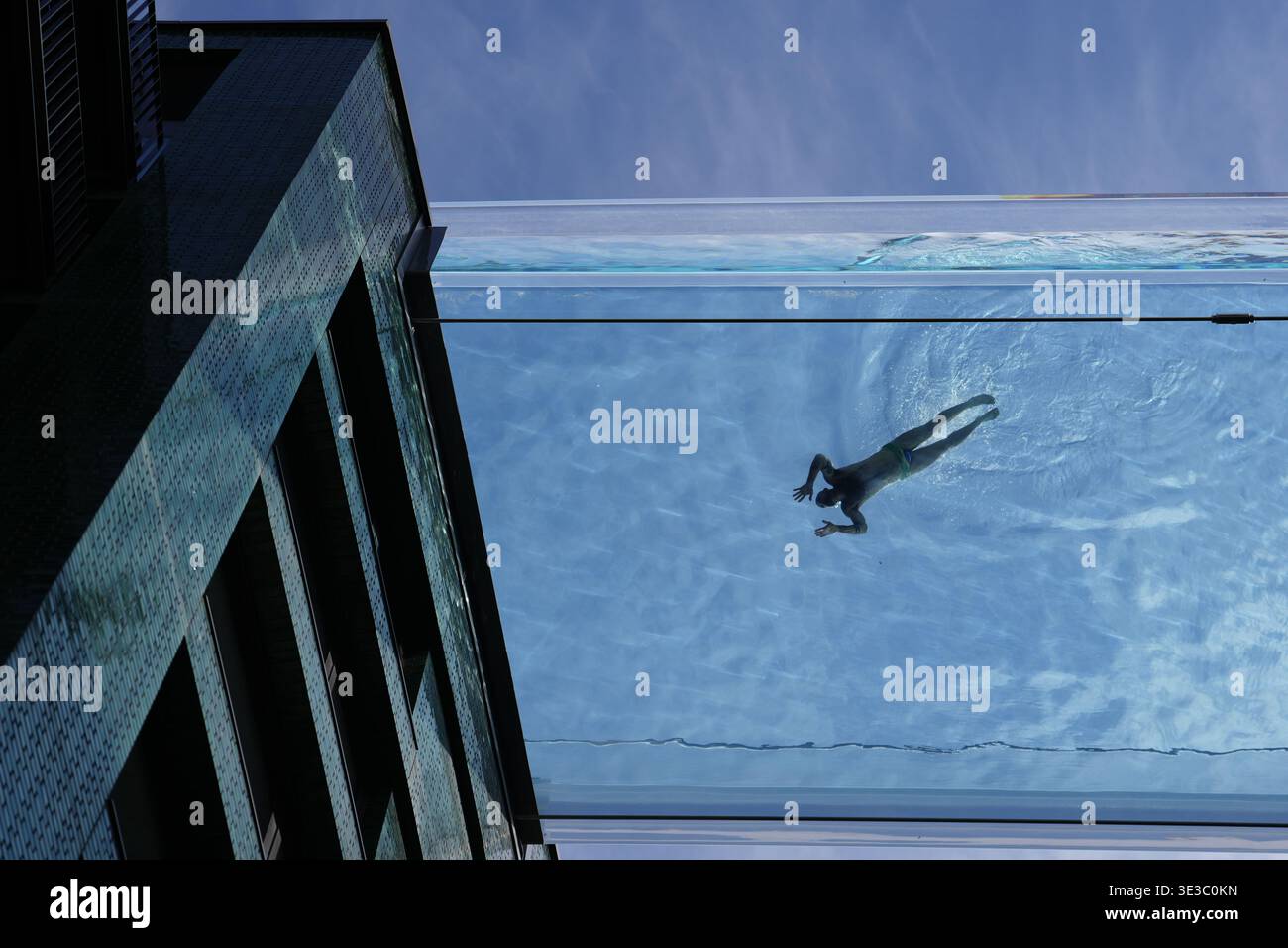 A swimmer in the Sky Pool, a transparent swimming pool suspended 35 ...