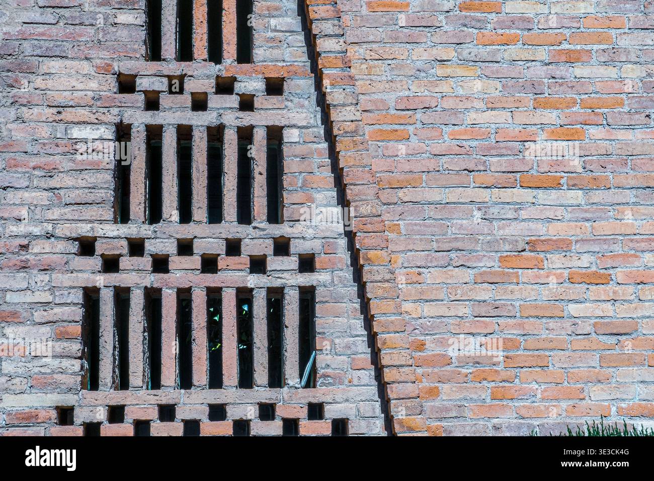 Abstract brick wall with vertical ventilation openings Stock Photo