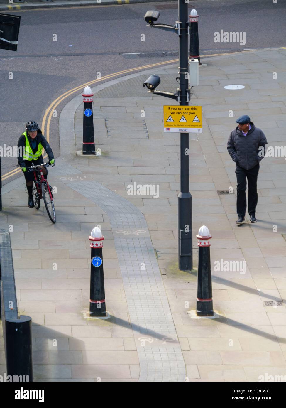 Checkpoint Signal On Rider Cyclist passes a pedestrian walking past a row of traditional City of ...