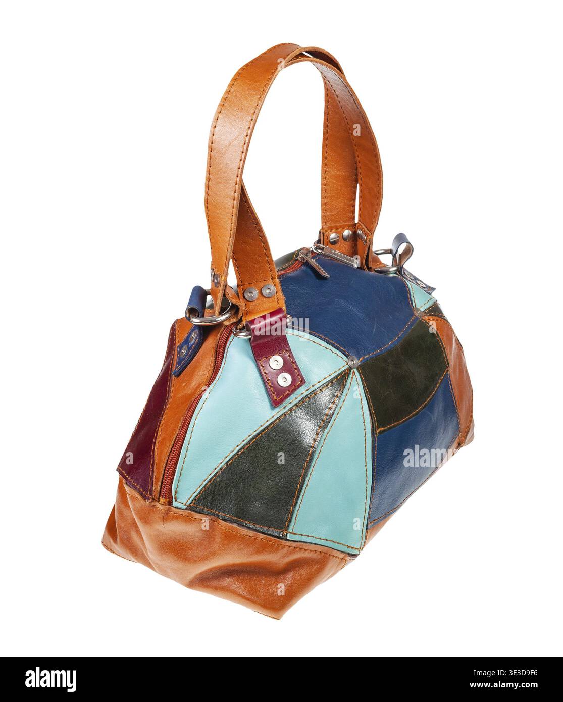 Handmade patchwork leather travel bag against white background Stock Photo