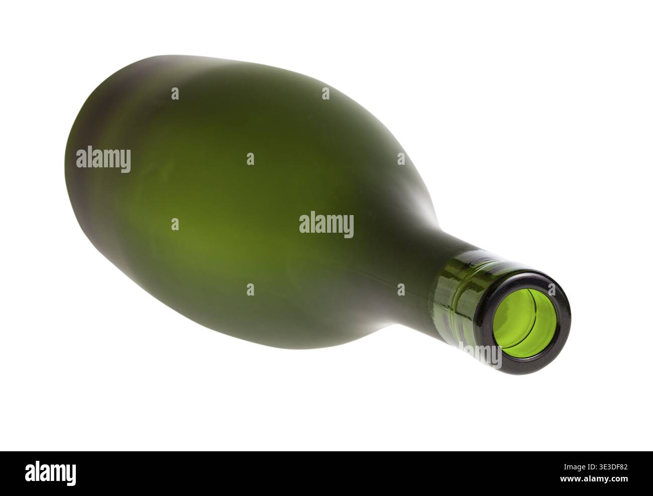 Overturned empty green brandy bottle against white background Stock Photo