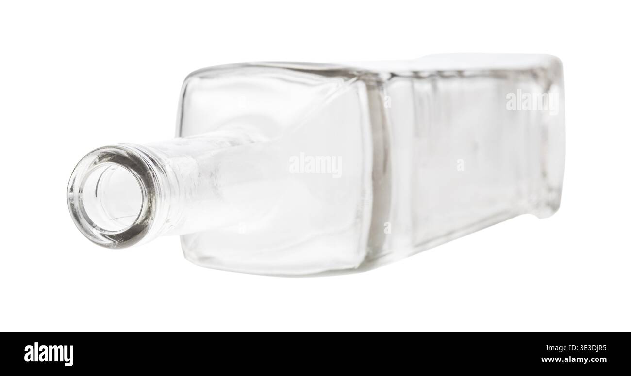 Overturned empty clear wine bottle against white background Stock Photo