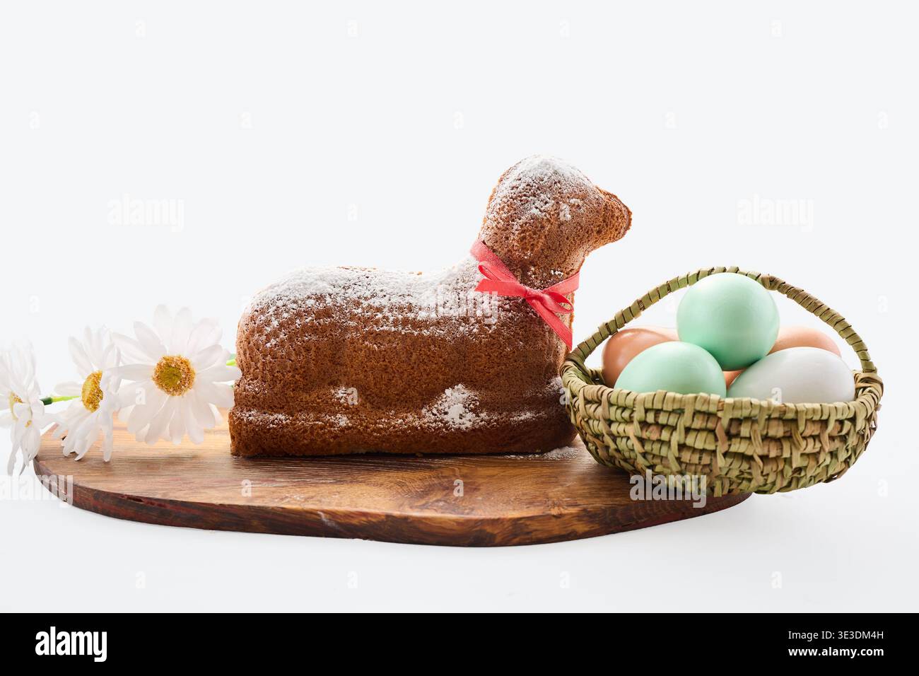 Easter lamb cake with colored eggs and flowers Stock Photo