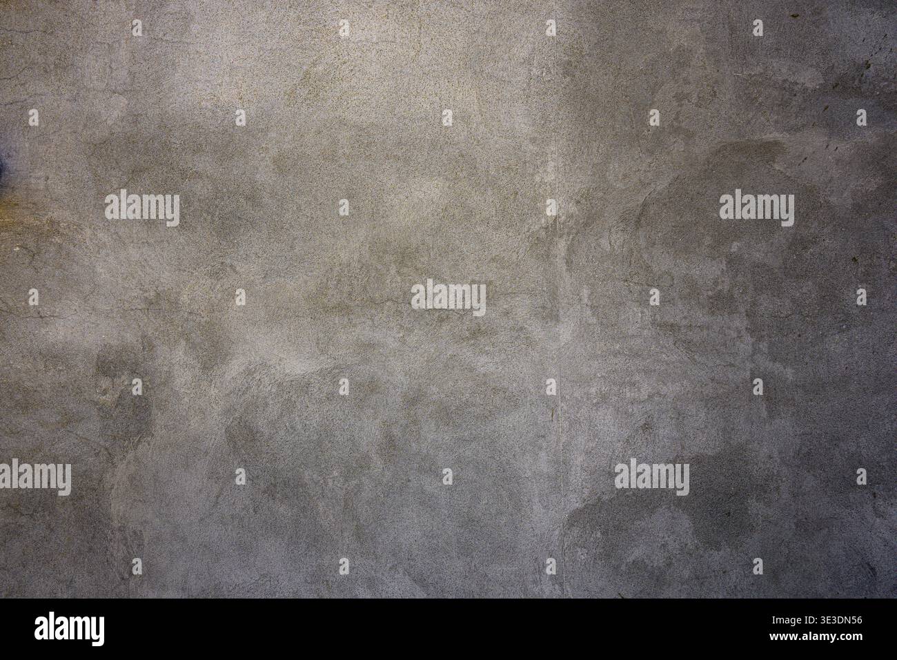 Textured gray concrete surface with subtle speckles and uneven lighting. Ideal for backgrounds in design, architecture, or industrial projects. Neutra Stock Photo