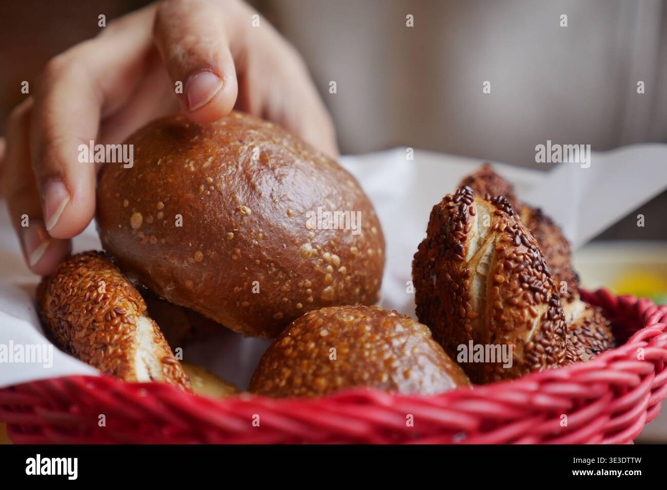 Freshly baked bread rolls in a red basket Stock Photo