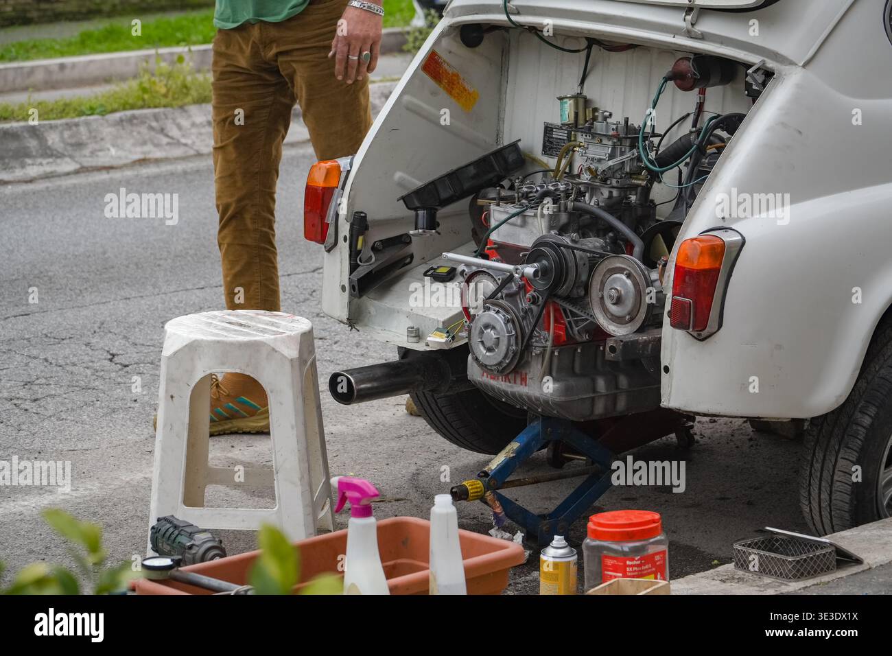 Italian man repairing vintage Fiat 500 Abarth rear engine on Rome ...