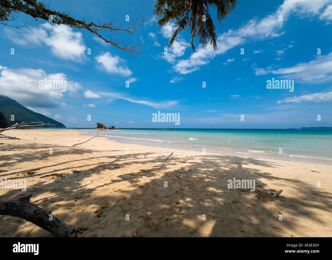 Sabang Beach in Puerto Princesa, Palawan, Philippines, with soft sand, turquoise water, and palm tree shadows under a bright tropical sky. - Smartphone Captured Stock Image