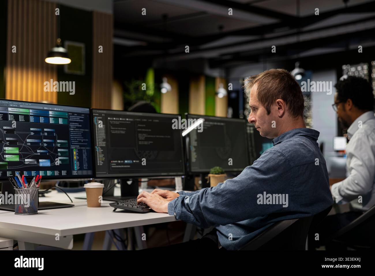 Computer scientist writing code, developing machine learning APIs. IT specialist in tech startup using PC to troubleshoot software errors using artificial intelligence, resolving system crashes Stock Photo