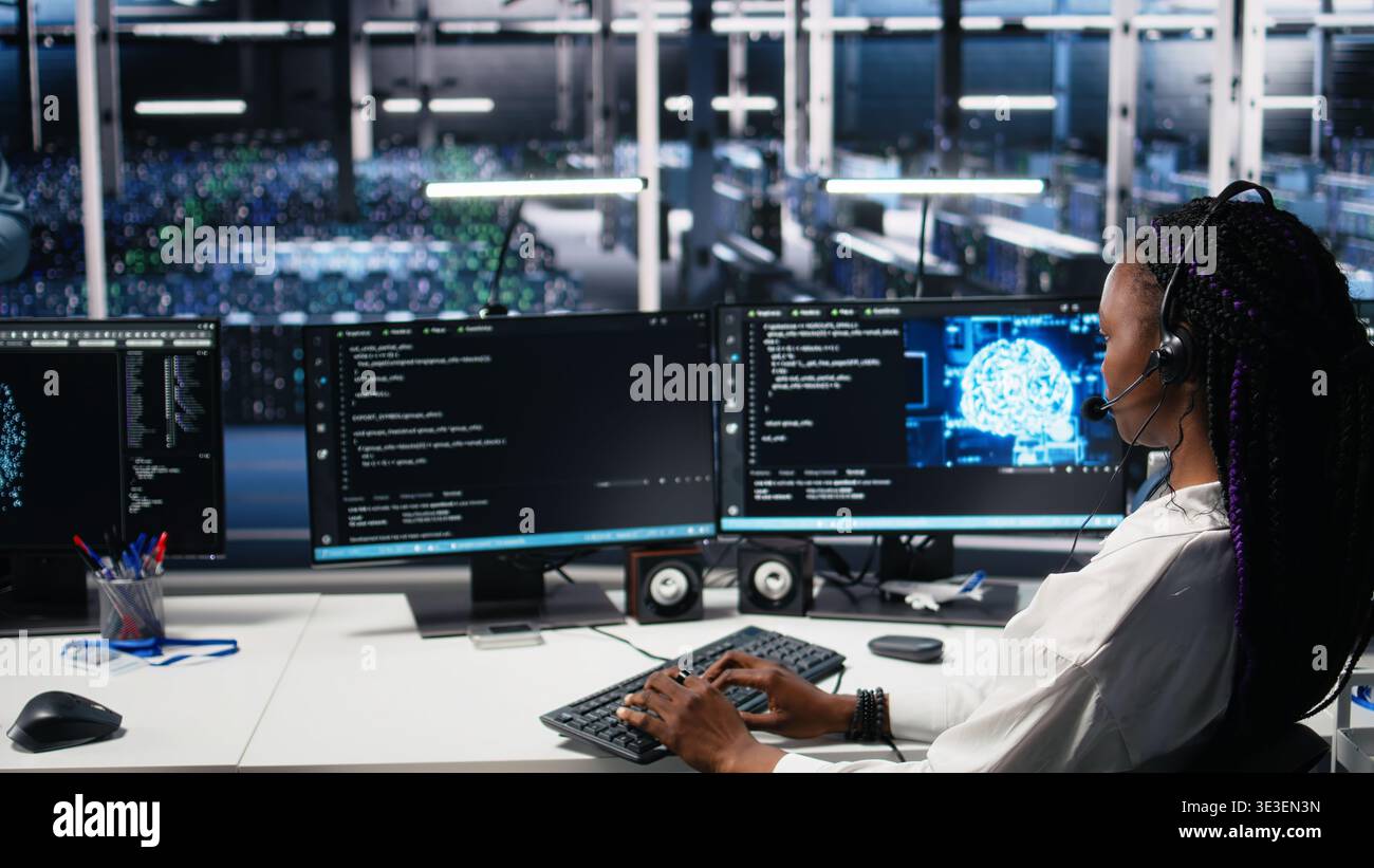 Data center software developer using AI assistant to provide user technical support. Server farm IT expert managing live support calls assisted by large language model chatbot, camera A Stock Photo