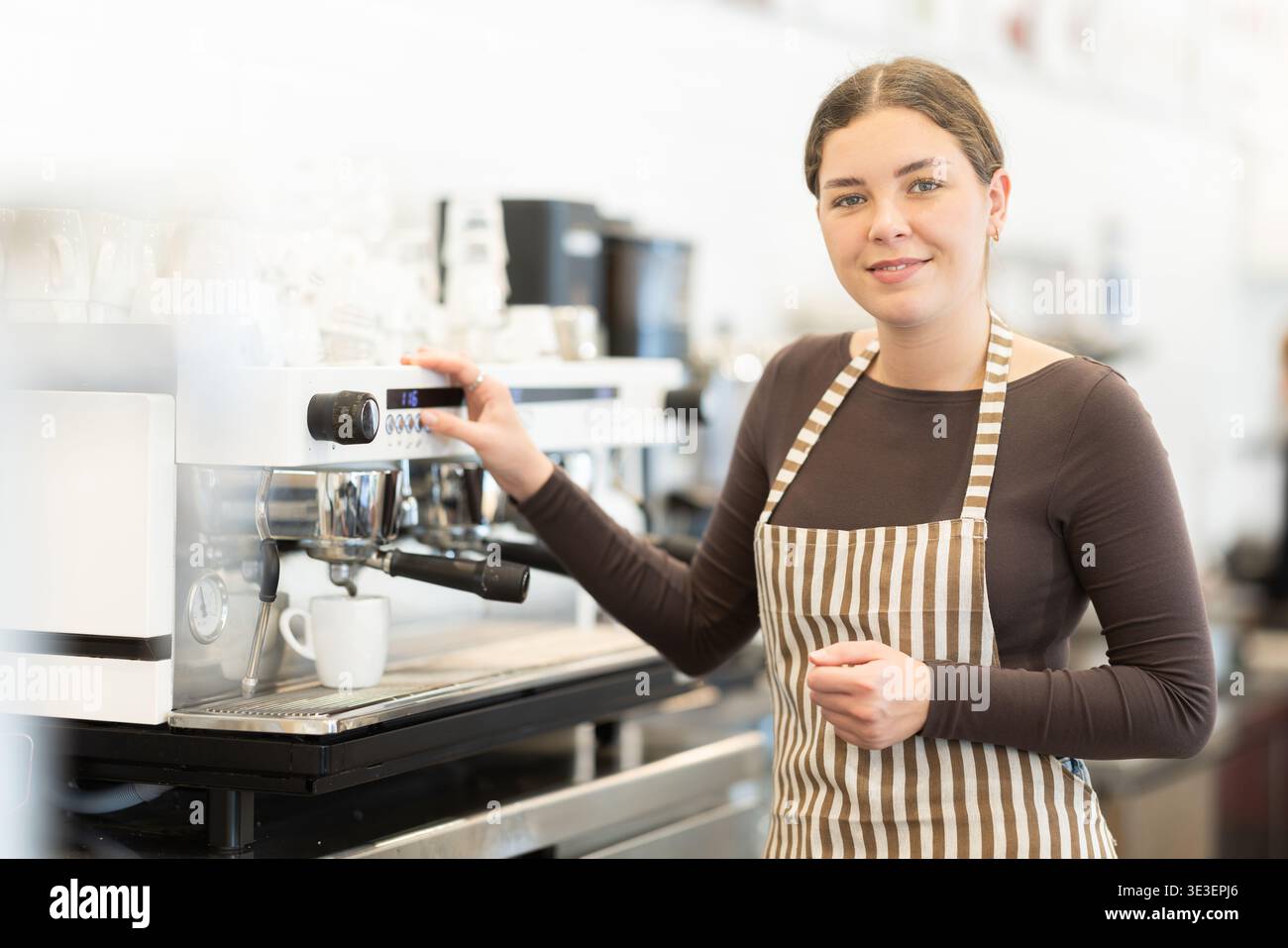 Woman barista making coffee Stock Photo