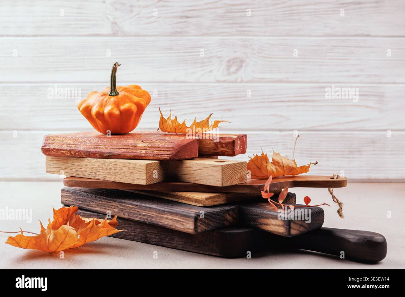 Rustic thanksgiving concept with pumpkin and cutting boards Stock Photo