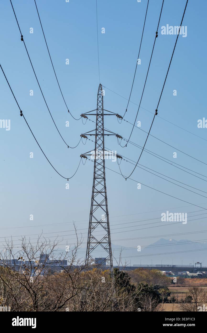 Portrait view high-voltage transmission tower and arcing power lines ...