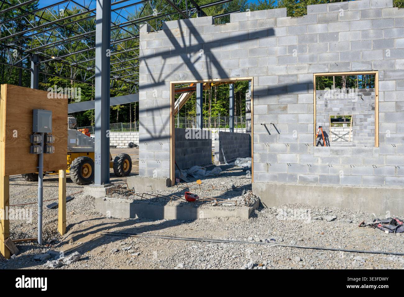Concrete masonry unit, cmu, blocks wall under construction, with window and door openings. Stock Photo