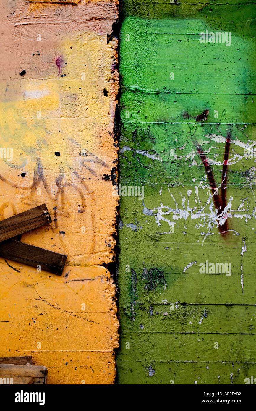 wall with old yellow and green paint Stock Photo