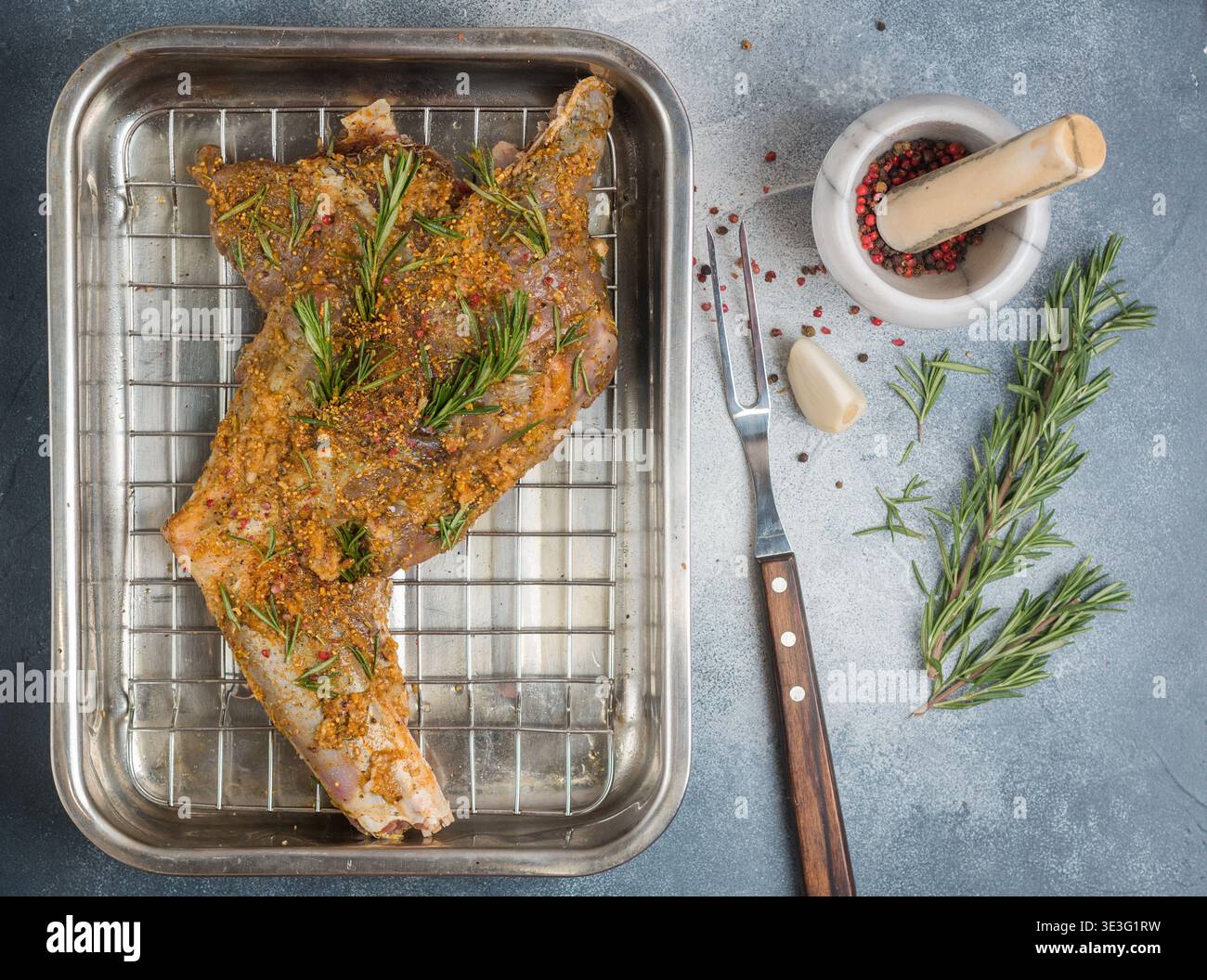 Raw Roe Raw roe deer leg with spices, garlic and rosemary for baking. Delicious ...