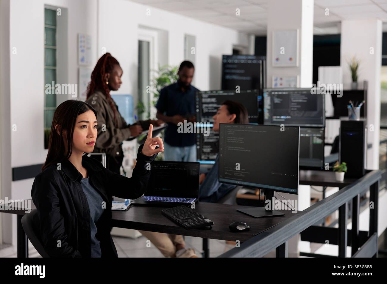 Asian web developer working with hologram and coding language in programming software company. Programmer analyzing holographic html code and augmented reality to develop new server interface. Stock Photo