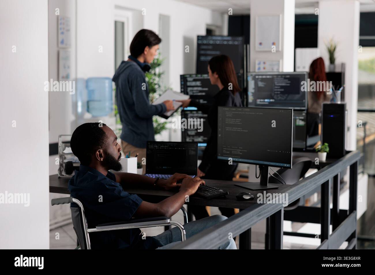 Disabled african american it engineer working on server program with computer, typing html code in coding office. web developer with chronic disability writing script with system algorithms. Stock Photo