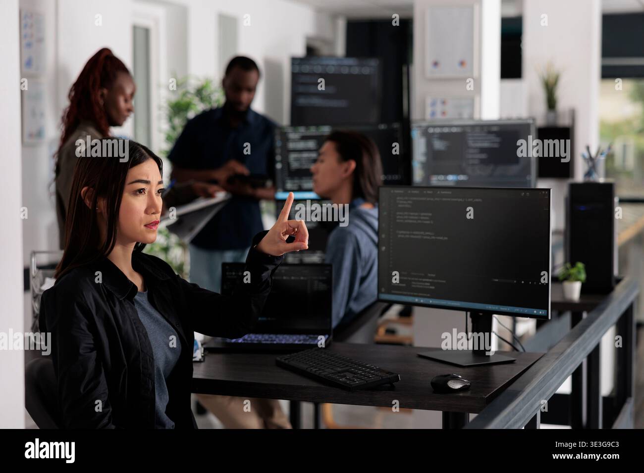 Concentrated web developer working with hologram and coding language in programming it office room. System engineer analyzing holographic script and augmented reality to develop new server interface. Stock Photo