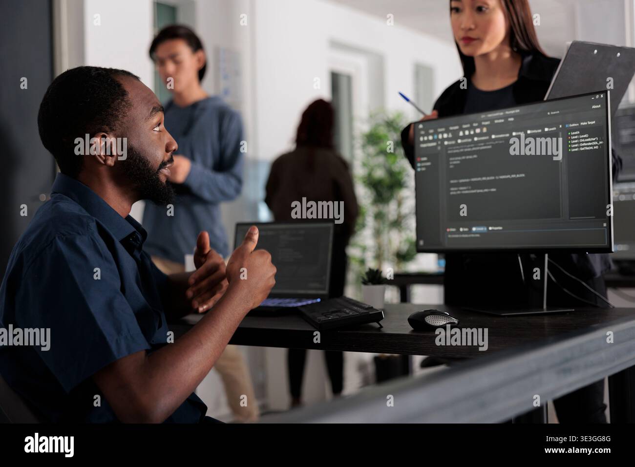 Diverse group of web developers analyzing html code and comparing data script in big data office room. Cloud programers working on system interface algorithm in development company. Stock Photo