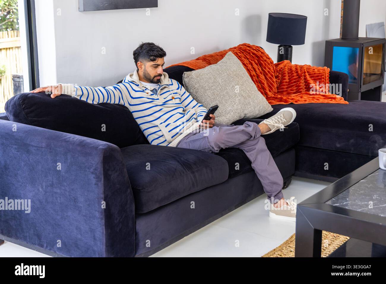 Indian man reclining on dark hi-res stock photography and images - Alamy