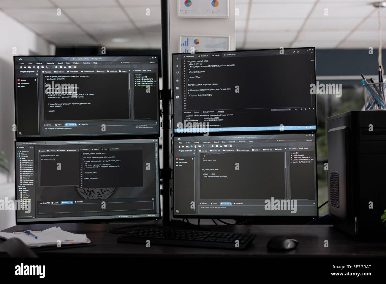 Computer monitors on desk compiling programming html data algorithms in empty software company. Database network servers cloud computing in it agency room, code script language. Stock Photo
