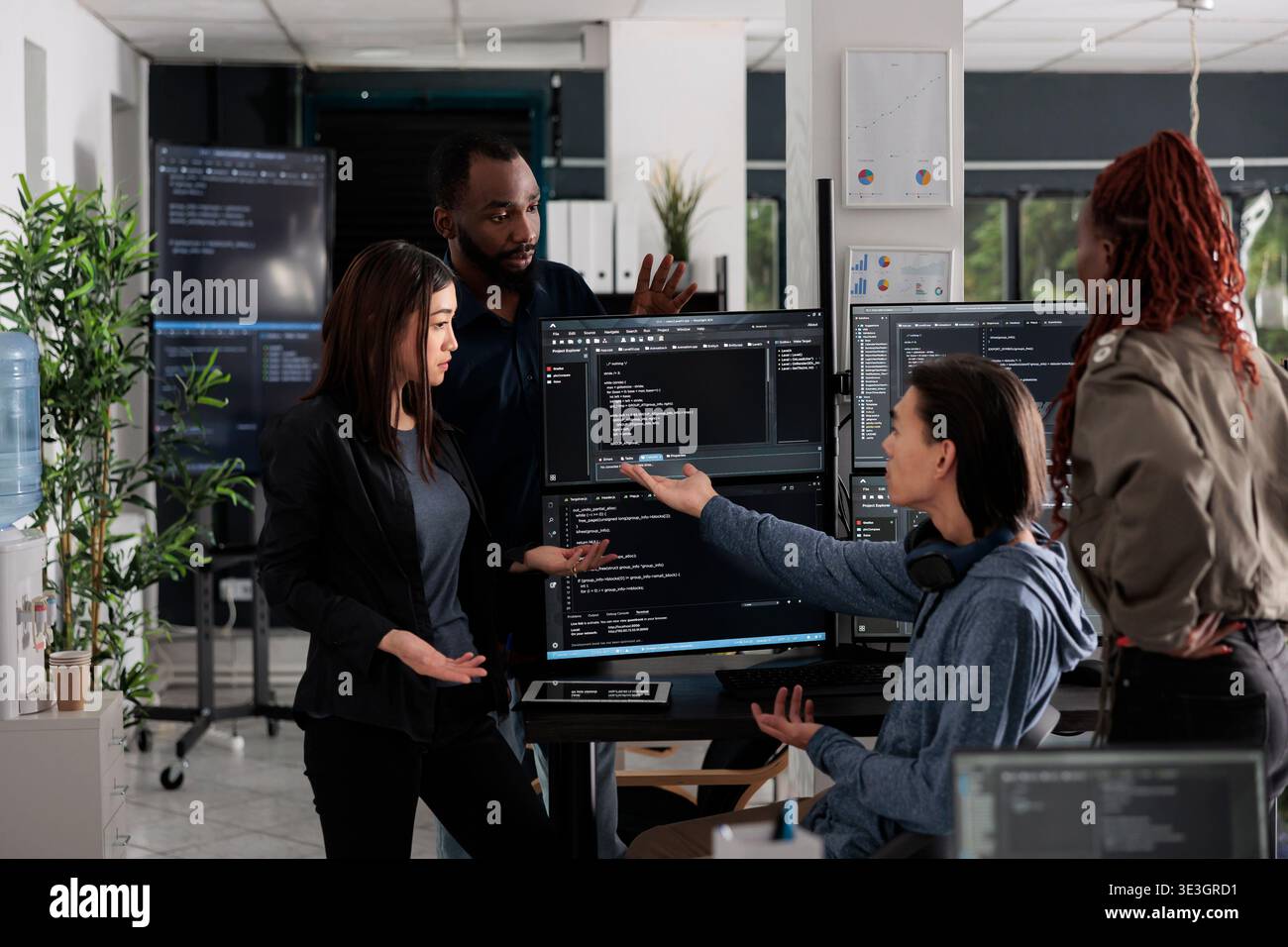 Multi ethnic web developers writing script while talking about develop cloud computing server. IT engineers having unexpected server error and no access to database, hacking attack. Stock Photo