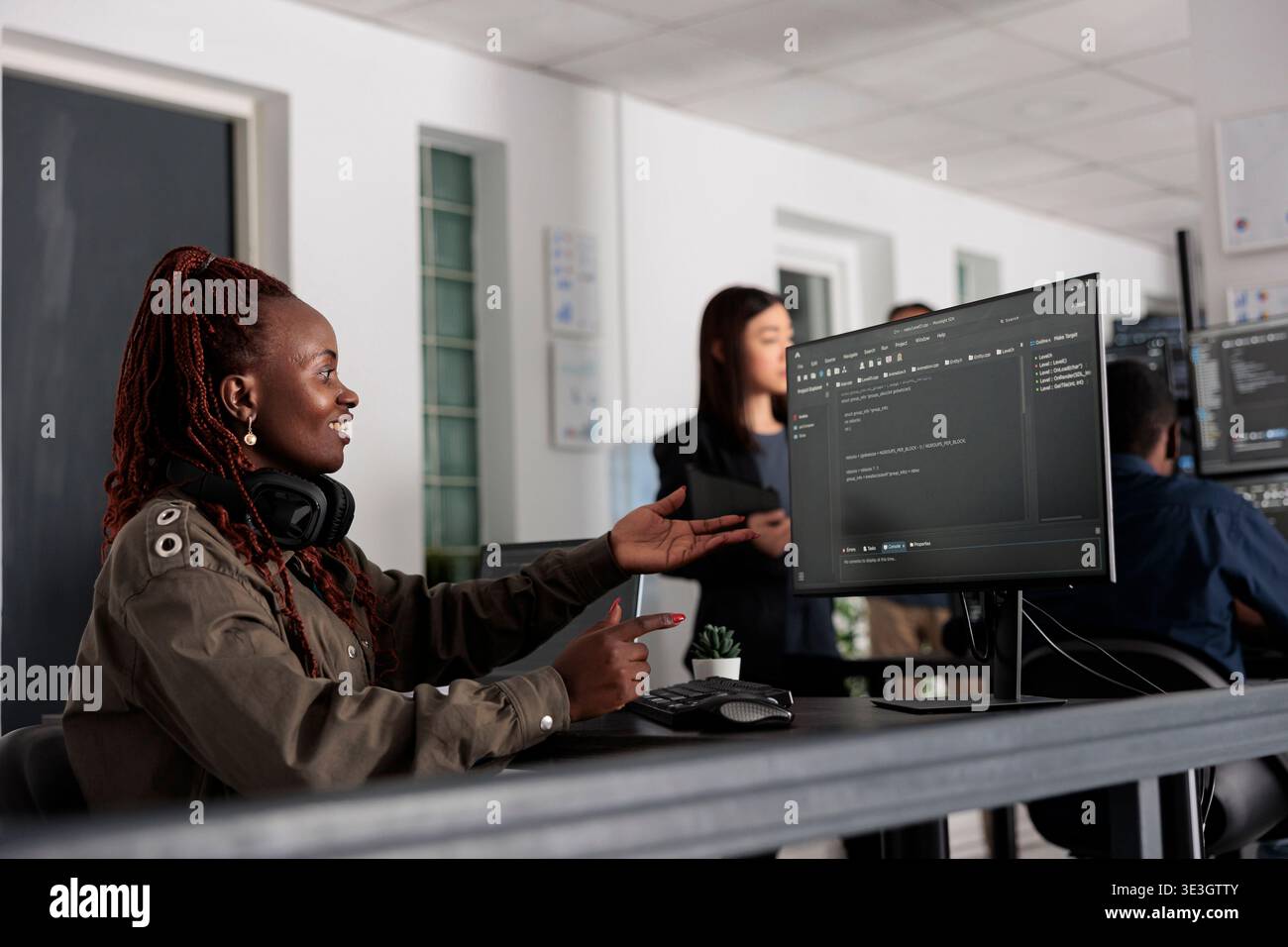 Smiling software developer programming server code algorithm on computer, typing sever data in big data office. Database engineer working on new user interface with online system to create algorithm. Stock Photo
