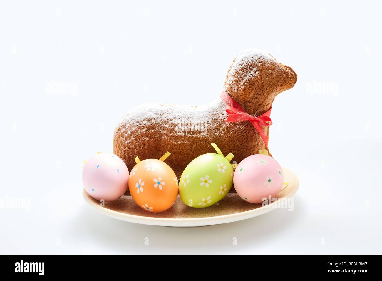 Easter lamb cake with colorful decorative eggs Stock Photo