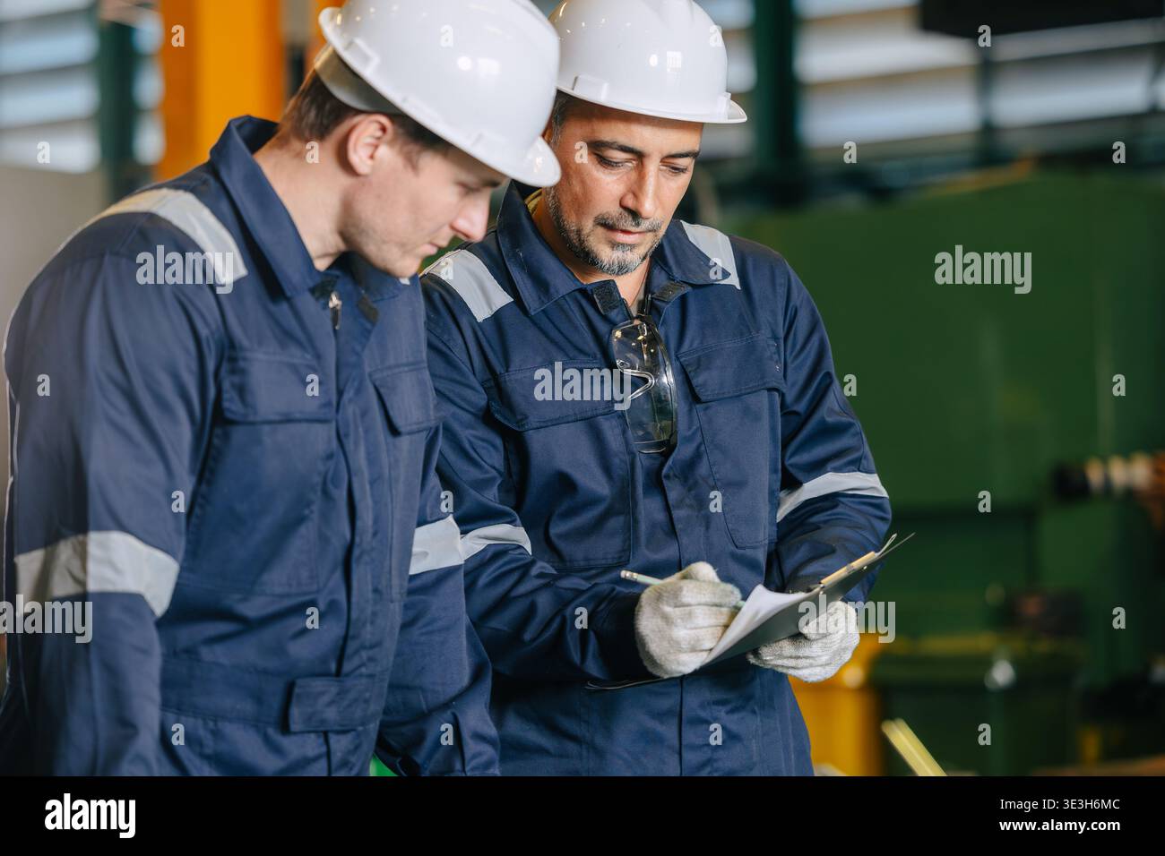Senior engineer team with young worker help together checking list with sheet document report. Stock Photo