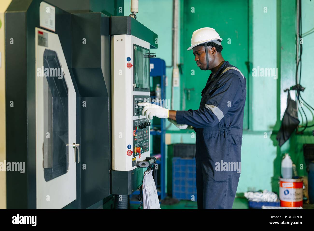 CNC Lathe Machine Engineer Operator Worker Working Entering Work Batch Production Program Data at Heavy Metal Factory Stock Photo
