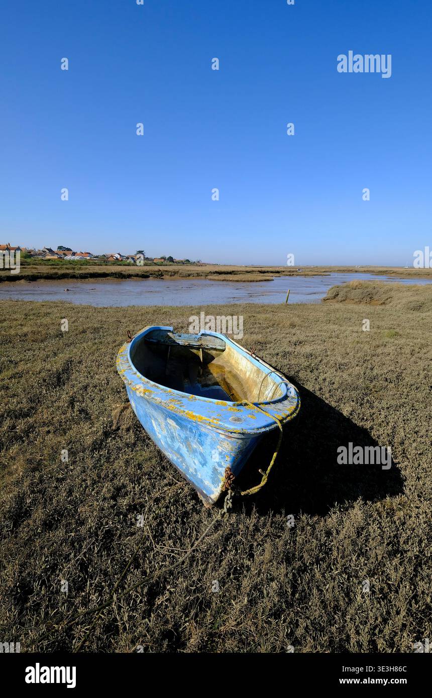 blue rowing boat on salt marshes, burnham deepdale, north norfolk, england Stock Photo