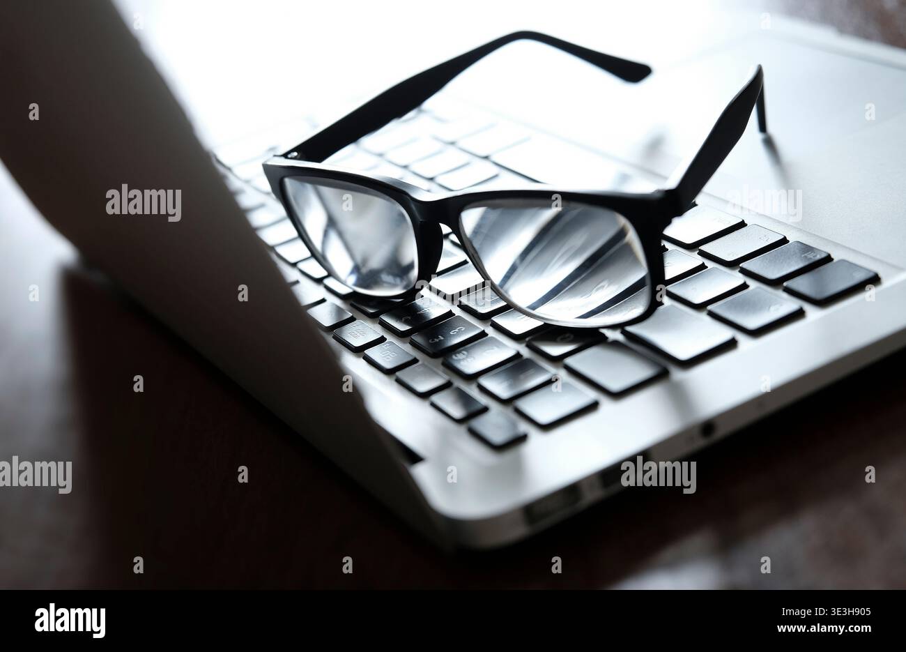 reading glasses on laptop computer keyboard Stock Photo