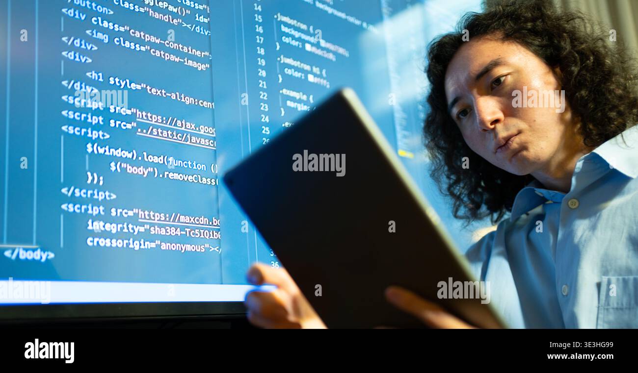 code analyst using big display, software developer focused on debugging with extensive monitor setup Stock Photo