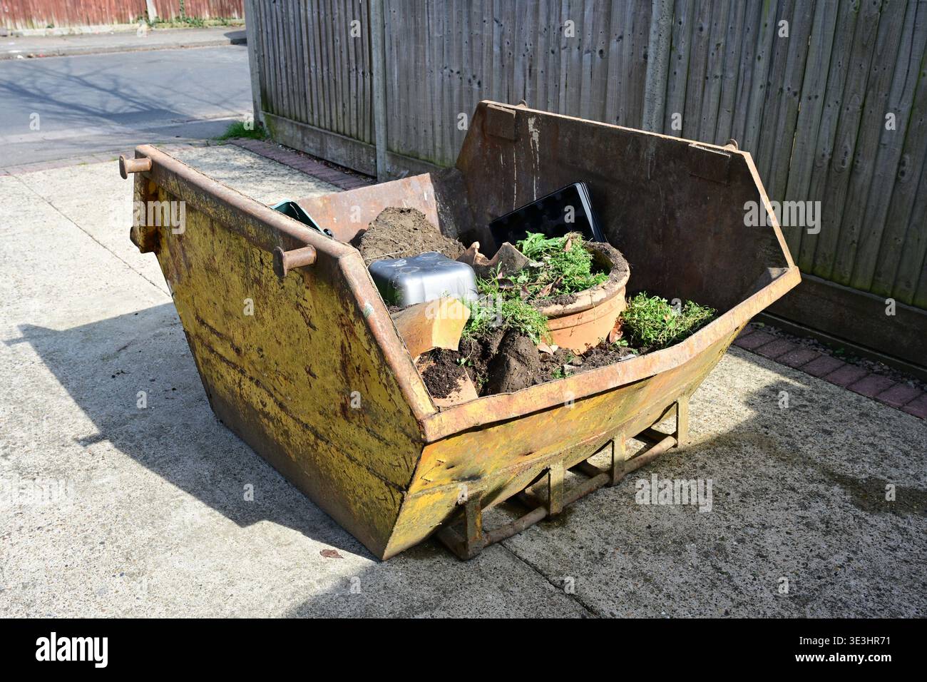Two Yard Mini Skip containing garden rubbish. Stock Photo