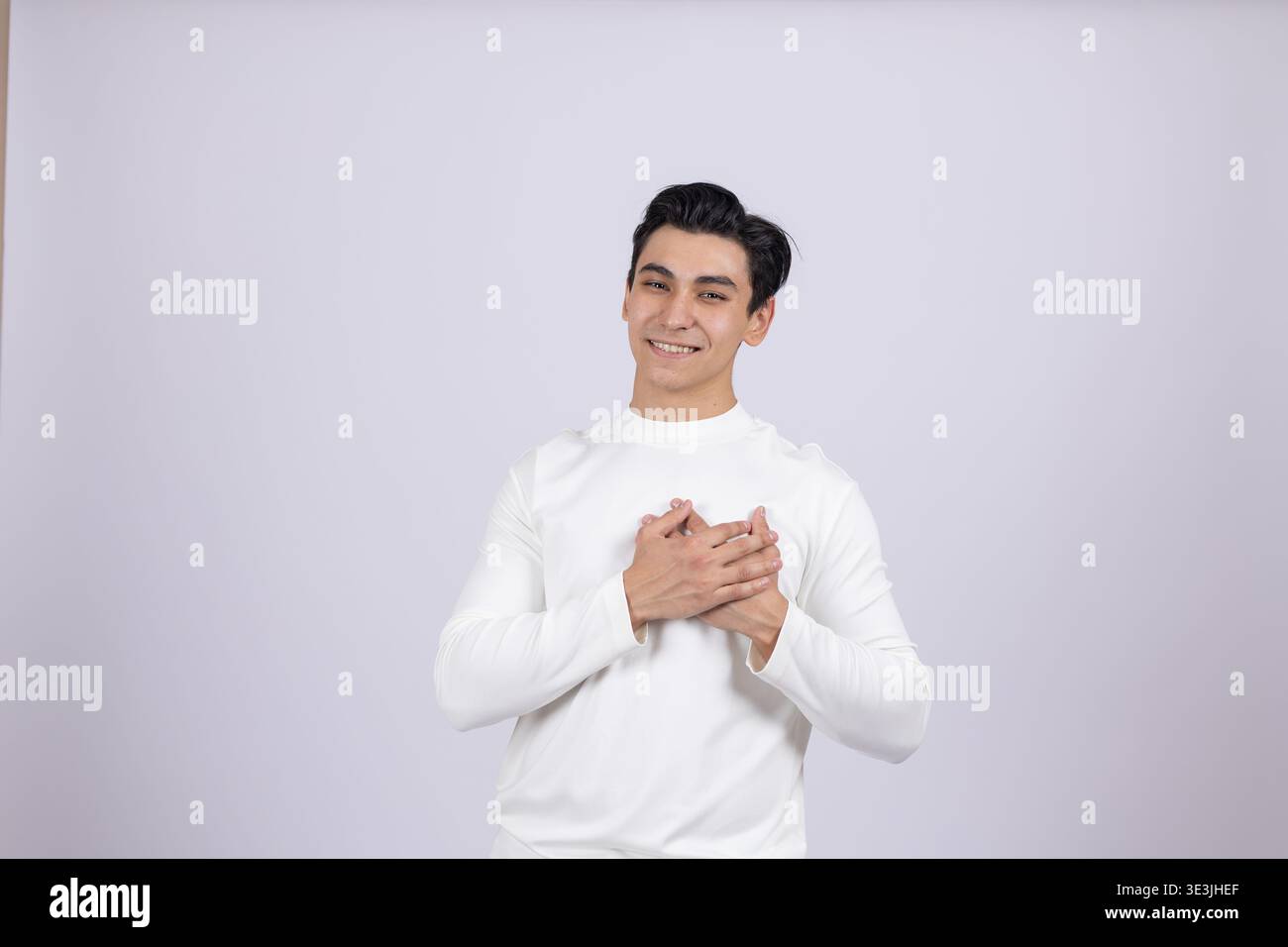 Man holding hands on chest in gratitude Stock Photo