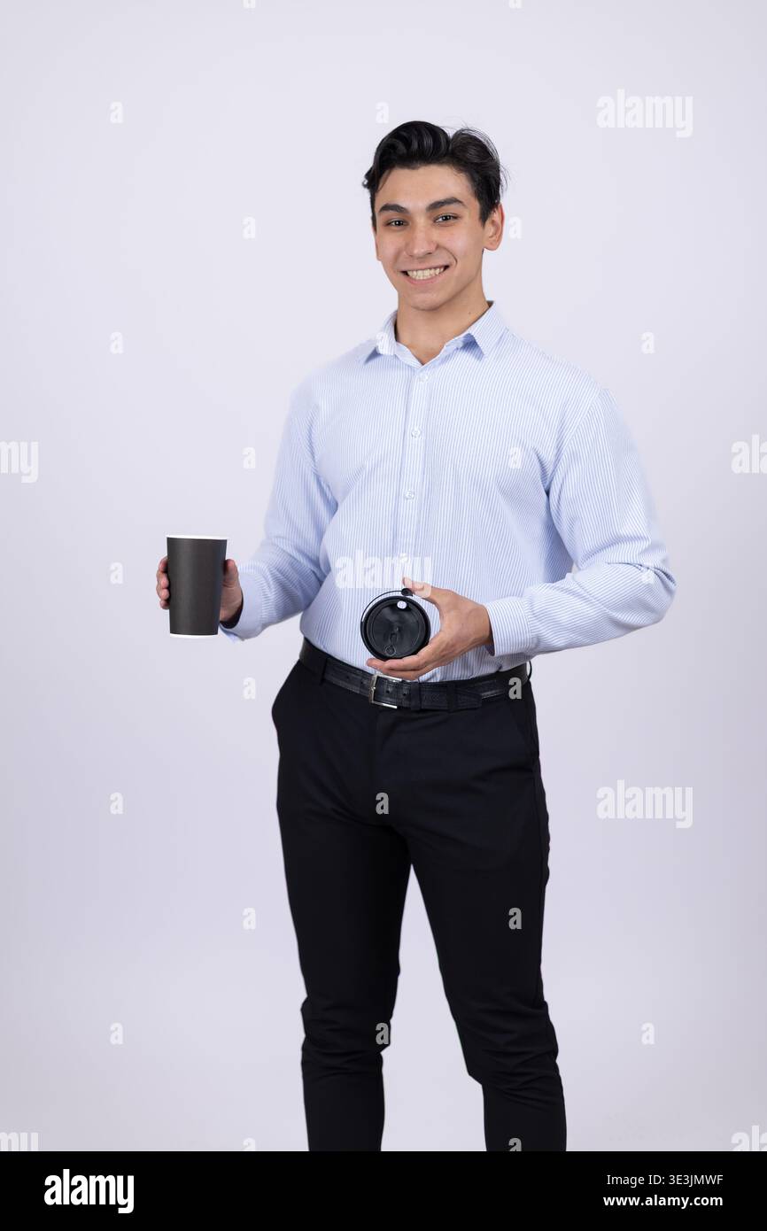 Young man holding a camera and a roll of film in the studio Stock Photo