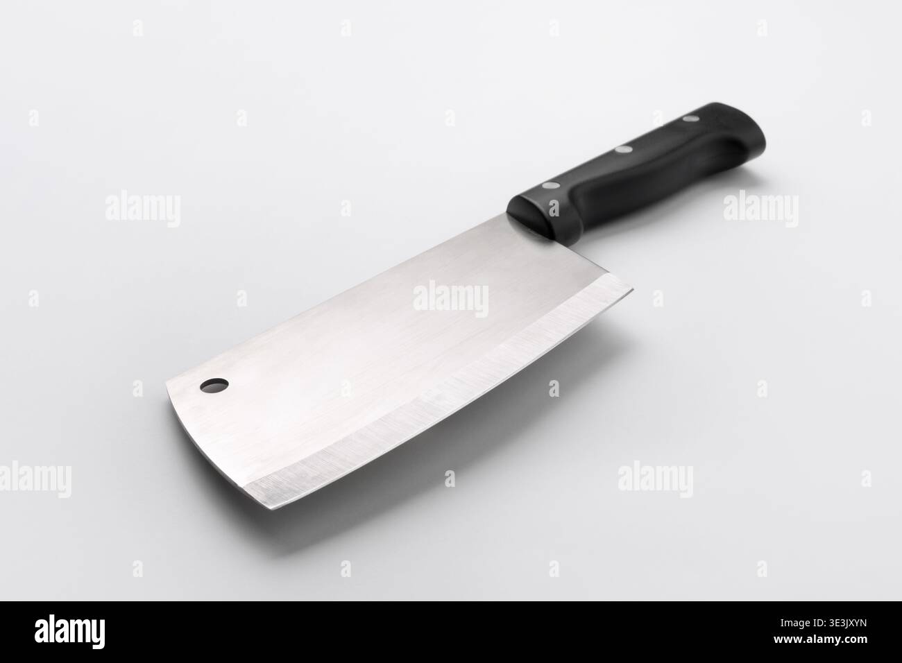 High-quality stainless steel meat cleaver with black handle, isolated on white background. Perfect for kitchen, cooking, or culinary themes. Stock Photo