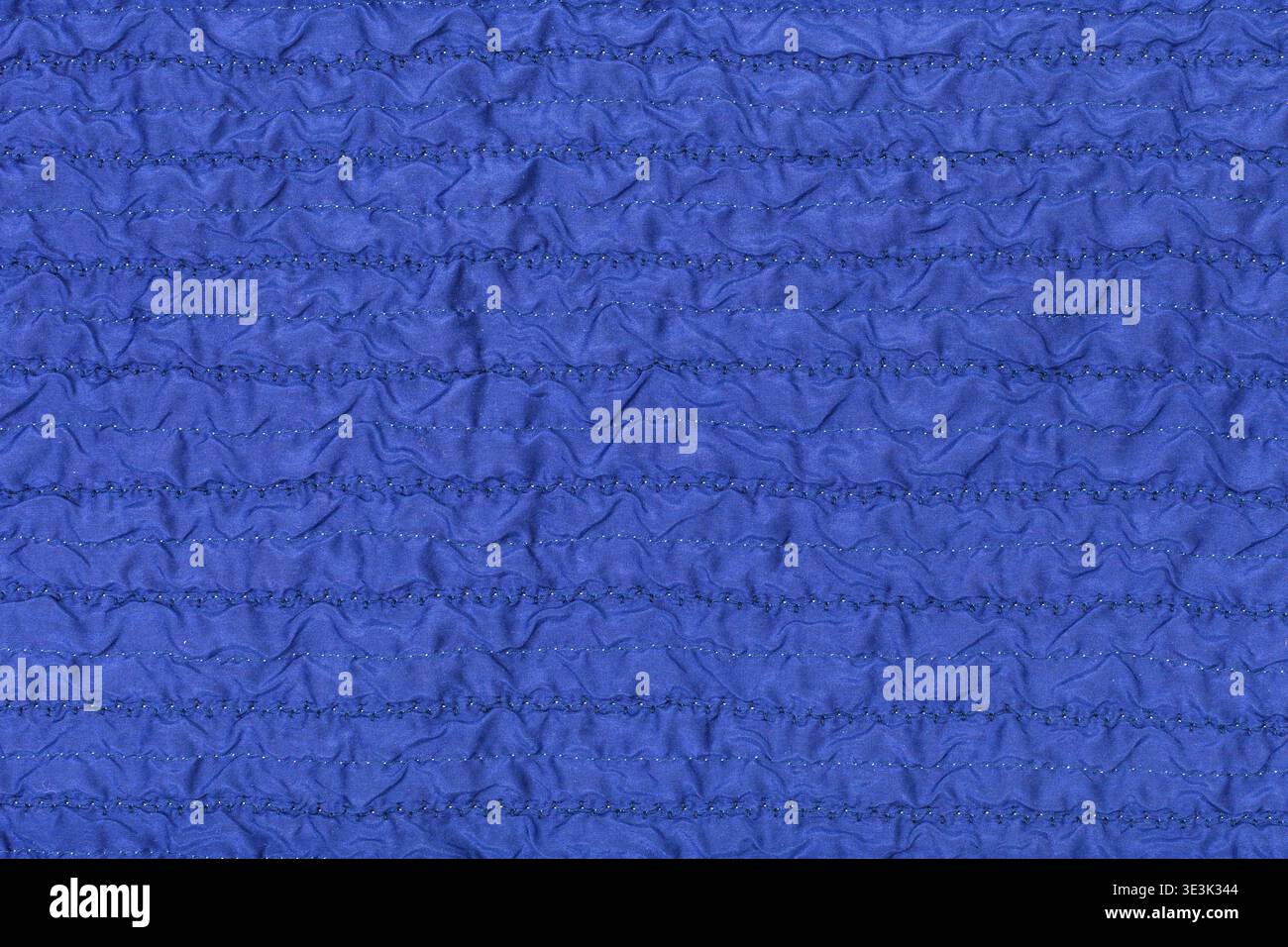 Textile background made from stitched, wrinkled blue silk fabric Stock Photo