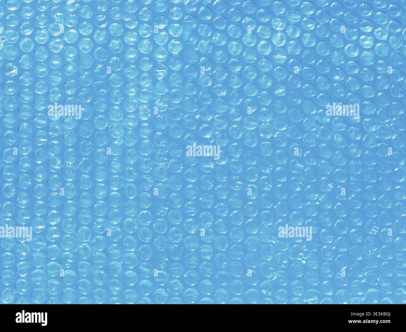 Bubble wrap background on blue water, close-up Stock Photo