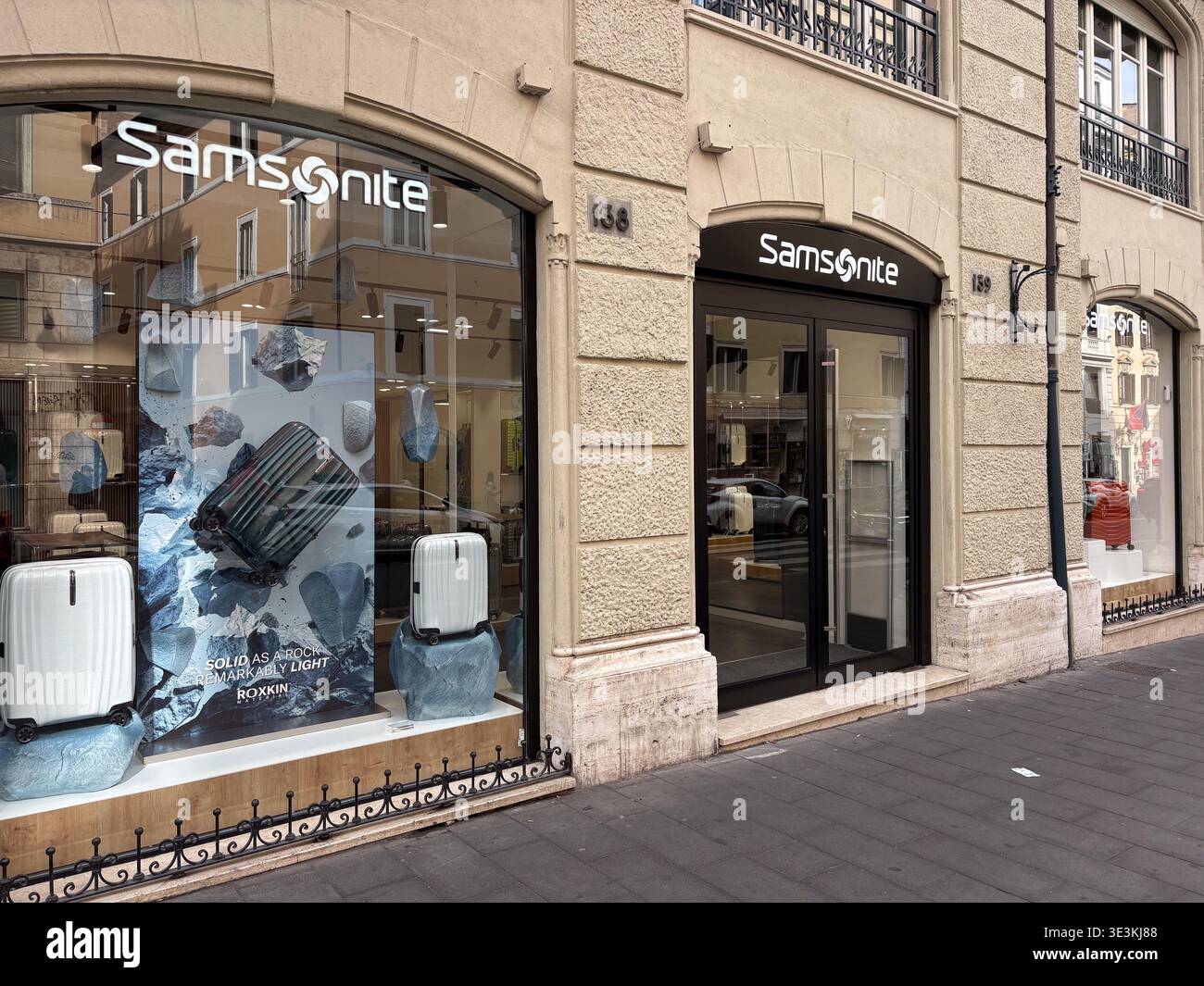 Samsonite shop exterior. Rome, Italy. Beige stone facade, modern window display featuring Roxkin luggage, travel concept. Stock Photo