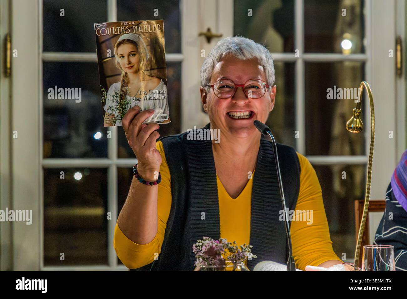 Mona Gabriel holds up a penny dreadful by Hedwig Courths-Mahler. Under the pseudonym Clara Bachmann, Mona Gabriel and a co-author published the biographical novel *A Happy Ending: The Rocky Road of Hedwig Courths-Mahler* in October 2025. Leipzig, Saxony, Germany Stock Photo