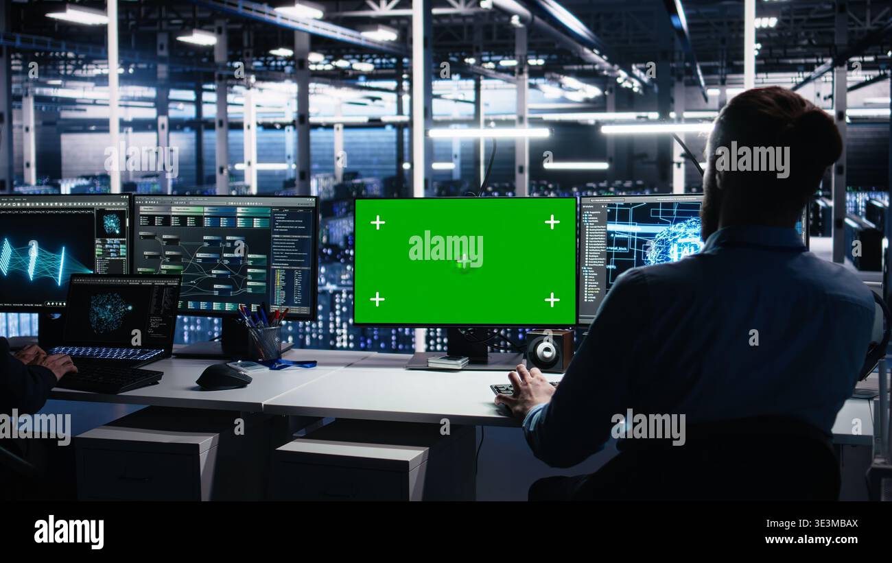 Data center engineer using machine learning algorithms on green screen PC to analyze datasets. Server farm worker using AI neural networks on mockup computer to recognize data patterns, camera A Stock Photo