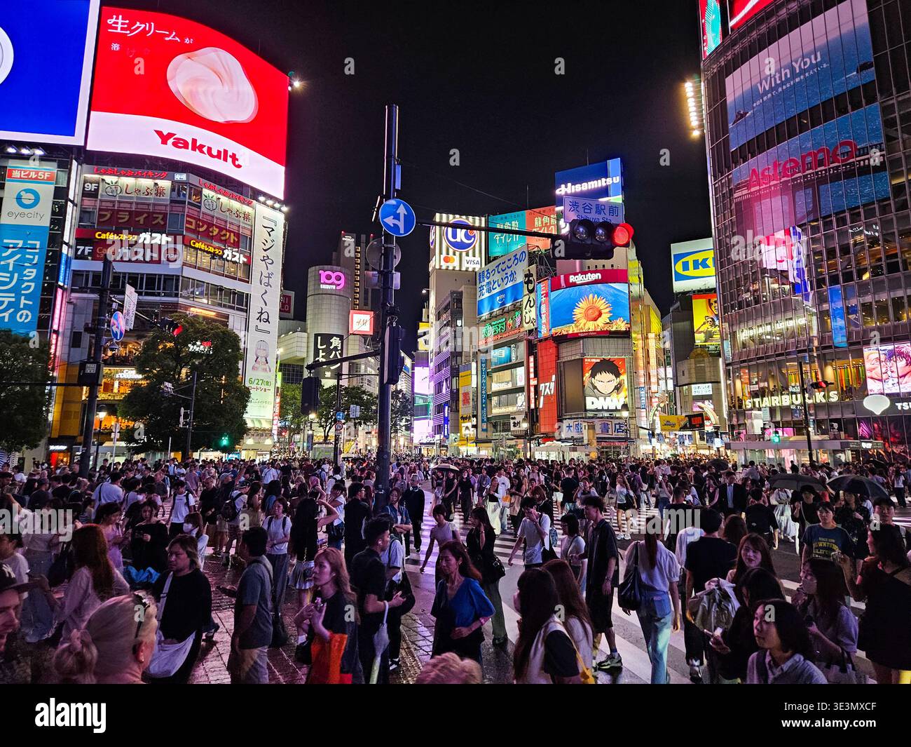 Nighttime Crowded Shibuya Crossing in Tokyo With Neon Billboards