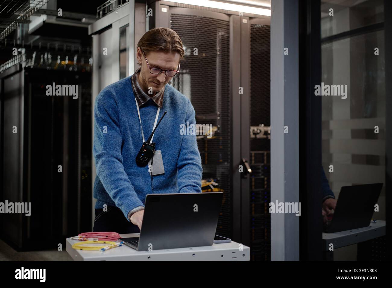 Middle Aged Caucasian Man Managing Server Maintenance Tasks Using Laptop Computer Stock Photo