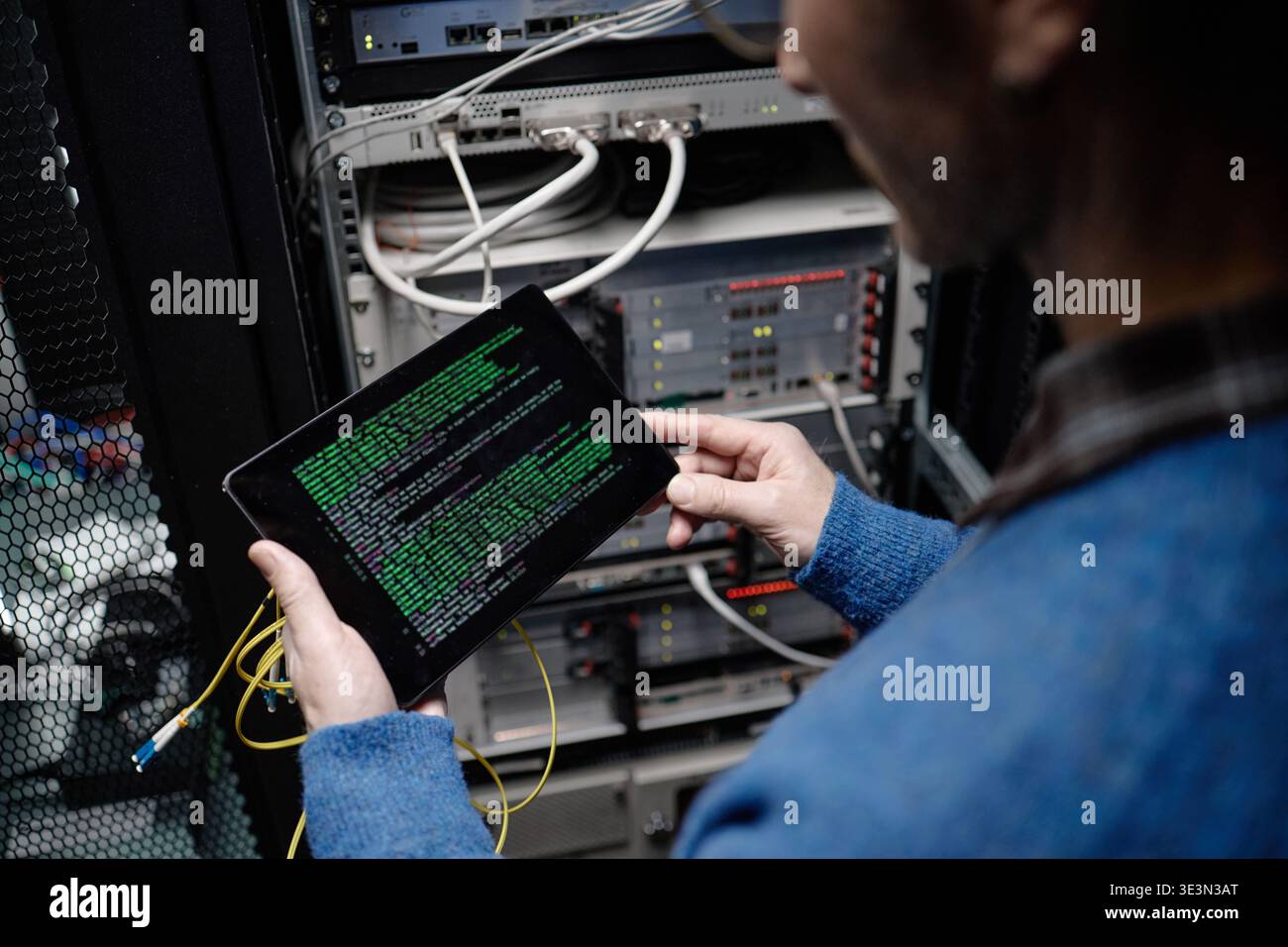 Middle Aged Caucasian Man Using Tablet While Working in Server Room Stock Photo