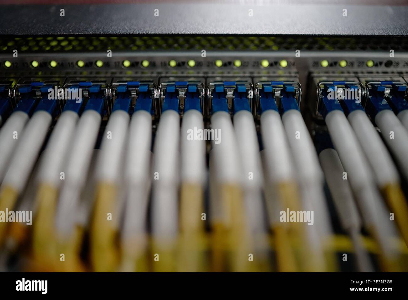 Network Cables Connecting to Server Rack in Data Center Environment Stock Photo